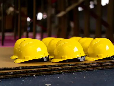 A row of yellow safety helmets