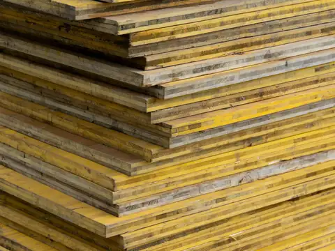 Stack of yellow shuttering plywood sheets