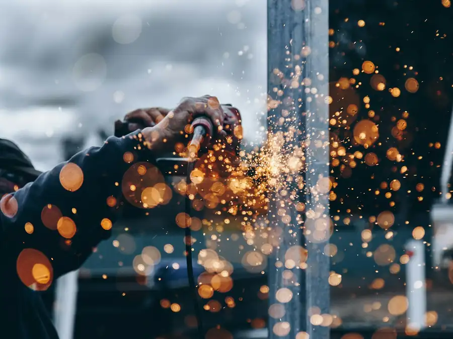 Cutting steel with a grinder, sparks flying