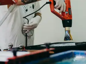 Heat gun being used on a workbench