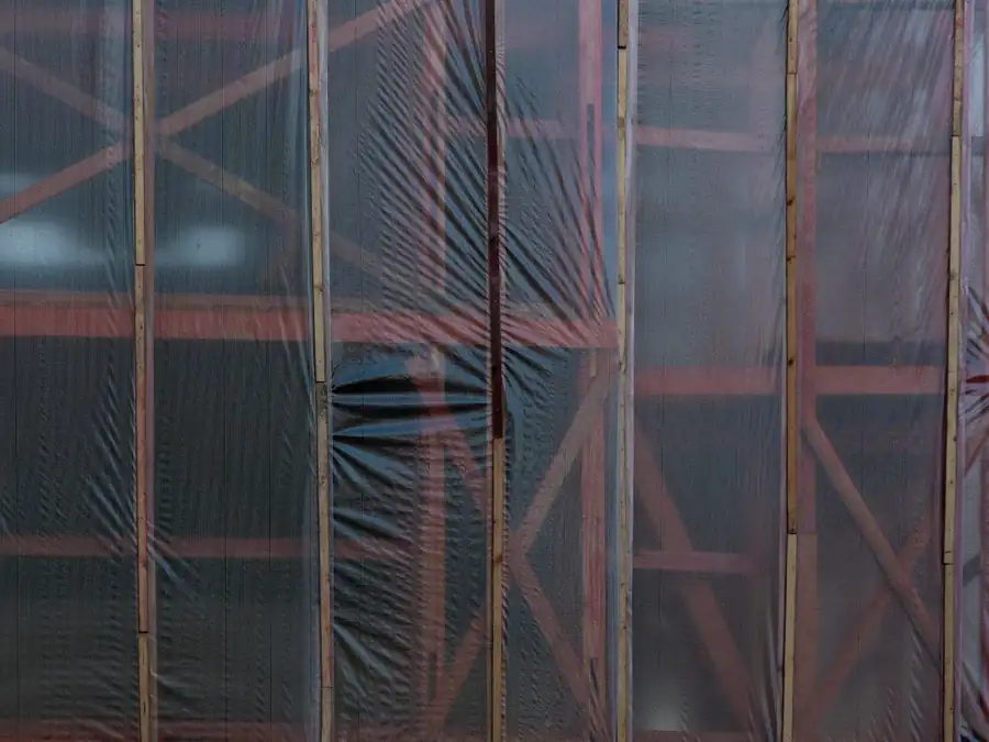 Scaffolding wrapped in polythene sheeting