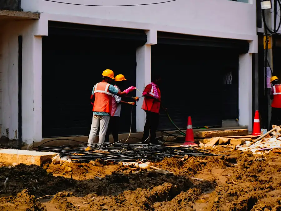 Site crew in helmets and high-visibility vests