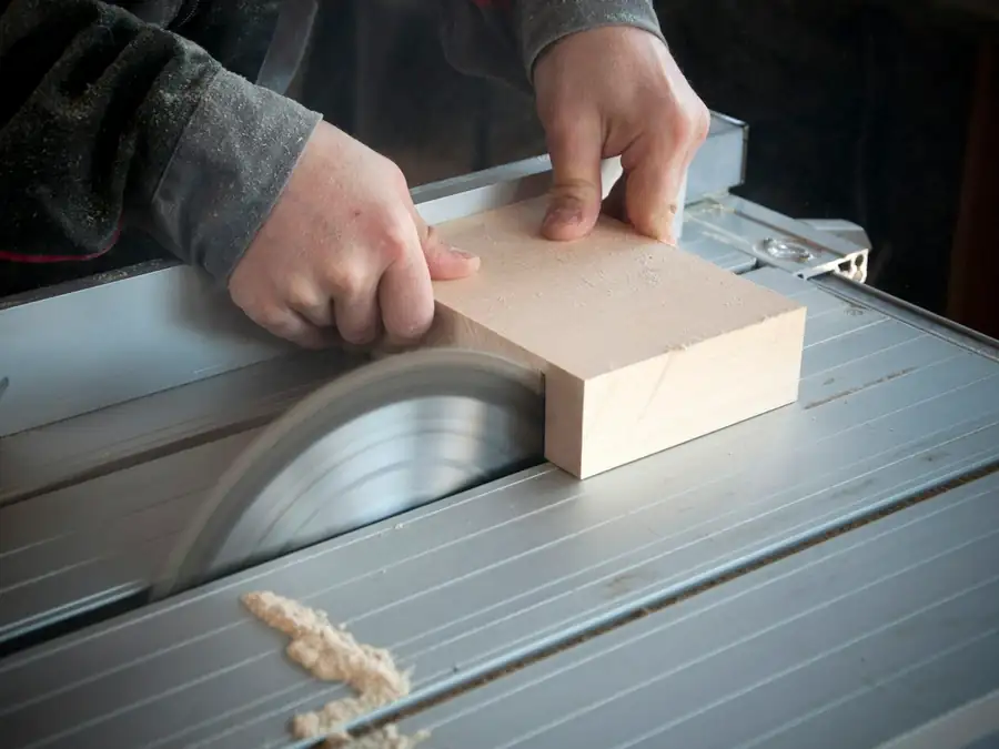 Cutting a board on a bench saw