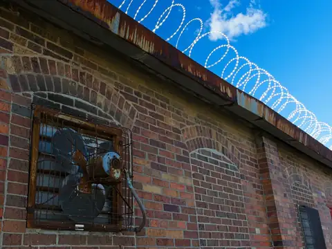 Razor wire coil along a boundary wall