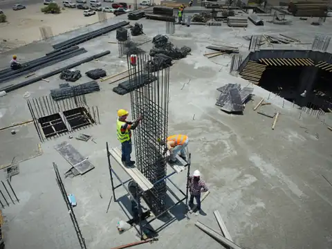 Aerial view of a building site with steel reinforcement and workers